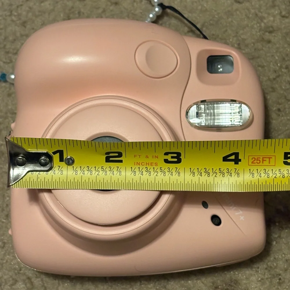 NWOT instax mini 7+ pink camera with a beaded lanyard (uses 4 AA batteries)